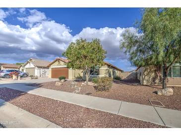 Charming single-story home with desert landscaping and a well-maintained front yard at 10465 E Dutchmans Trl, Gold Canyon, AZ 85118