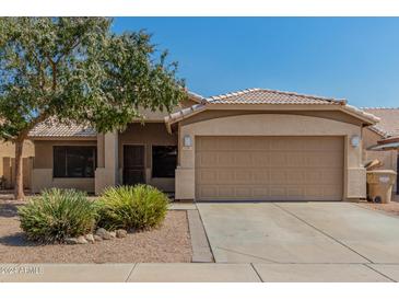 Inviting single-story home with low-maintenance landscaping and a two-car garage at 11341 W Barbara Ave, Peoria, AZ 85345