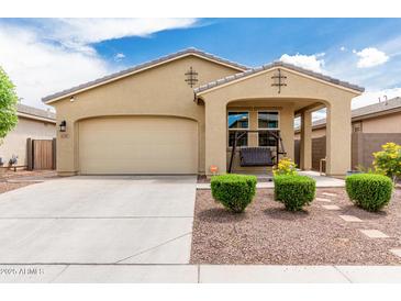 Charming single-story home featuring a covered porch with a swing and a well-maintained front yard at 12357 W Whyman Ave, Avondale, AZ 85323