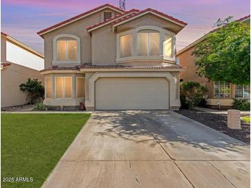 Charming two-story home with desert landscaping, arched windows, and a two-car garage at 1433 E Mineral Rd, Gilbert, AZ 85234