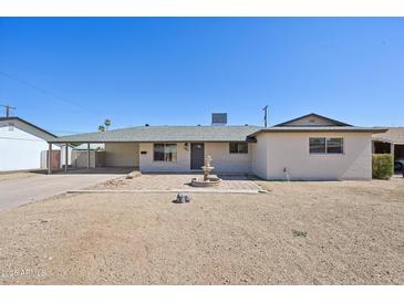 Charming single-story home featuring desert landscaping and a welcoming front patio with a decorative water fountain at 1532 W 6Th St, Tempe, AZ 85281