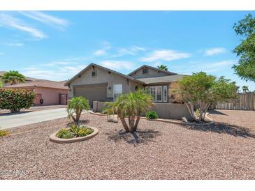 Charming single-story home with a well-manicured desert landscape and a two-car garage at 16461 W Central St, Surprise, AZ 85388
