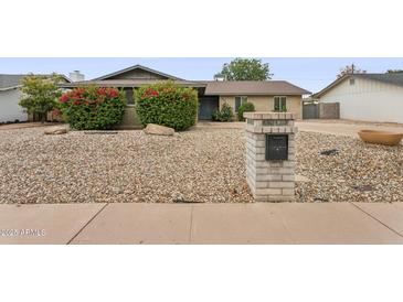 Charming single-story home with mature landscaping and a low-maintenance desert rock yard at 1649 W Royal Palm Rd, Phoenix, AZ 85021