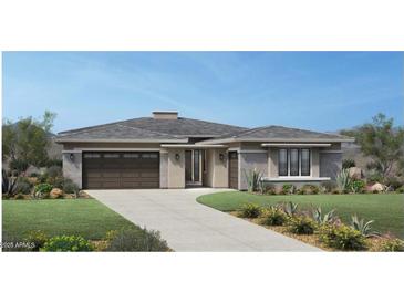 Stunning single-story home with a well manicured lawn, modern design, and a spacious two-car garage at 24000 S 218Th Pl, Queen Creek, AZ 85142