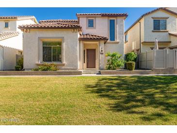 Charming home featuring a well-manicured lawn, inviting entryway, and a classic tile roof at 26521 N Babbling Brook Dr, Phoenix, AZ 85083