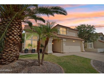 Charming two-story home featuring a well-manicured lawn and desert landscaping at 4043 N Ranier --, Mesa, AZ 85215