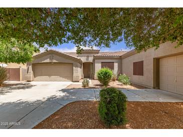 Charming single-story home with landscaped front yard and a two-car garage at 41804 W Carlisle Ln, Maricopa, AZ 85138