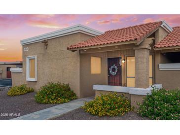 Charming single-story home with a red tile roof and desert landscaping at 420 W Yukon Dr # 4, Phoenix, AZ 85027