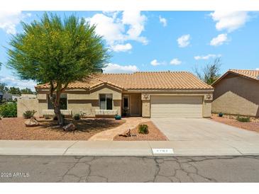 Charming single-story home featuring a well-manicured front yard with mature trees and a cozy desert landscape at 4202 E Brookwood Ct, Phoenix, AZ 85048