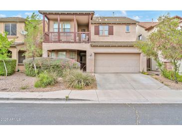 Charming two-story home with balcony, manicured landscaping, and a two-car garage at 4408 W Heyerdahl Dr, New River, AZ 85087