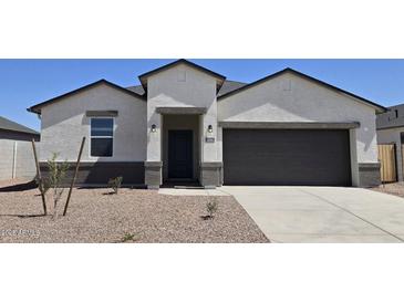 Charming single-story home with a two-car garage, desert landscaping, and a covered entryway at 5806 E Axle Ln, San Tan Valley, AZ 85140