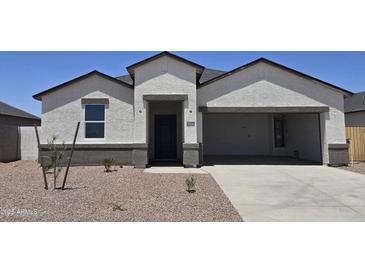Charming single-story home featuring a low-maintenance yard, two-car garage and covered front entry at 5806 E Axle Ln, San Tan Valley, AZ 85140