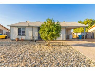 Charming single-story home with low maintenance desert landscaping and covered parking at 6960 W Berkeley Rd, Phoenix, AZ 85035