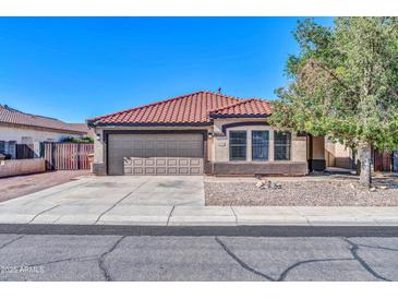 Charming single-story home with a red tile roof, desert landscaping, and a two-car garage at 10541 W Foothill Dr, Peoria, AZ 85383