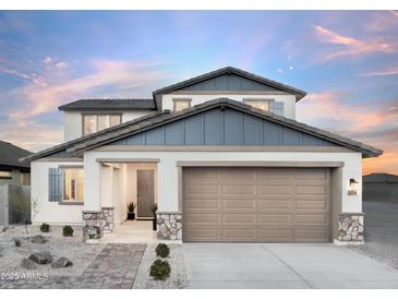 Charming two-story home showcasing a manicured front yard, a neutral color palette, and a spacious two-car garage at 15159 W Gray Fox Trl, Surprise, AZ 85387