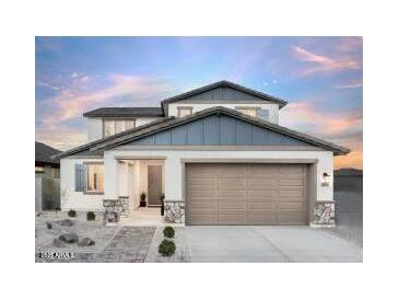 Charming two-story home with a two-car garage, stone accents, and a well-manicured front yard at 15159 W Gray Fox Trl, Surprise, AZ 85387