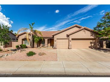 Charming home featuring a spacious three-car garage and well-maintained desert landscaping at 18021 N 53Rd St, Scottsdale, AZ 85254