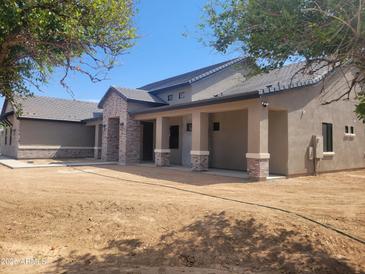 Beautiful single story home with brick facade and covered porch at 18035 E San Tan Blvd, Queen Creek, AZ 85142