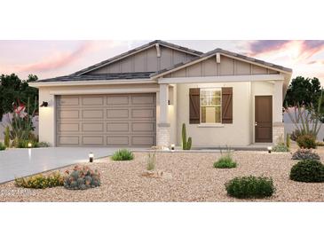 Inviting single-story home with desert landscaping, a two-car garage, and a charming covered entry at 1953 S 246Th Ln, Buckeye, AZ 85326