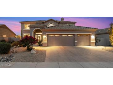 Charming two-story home featuring a three-car garage, desert landscaping and a lovely bougainvillea bush at 22233 N 54Th Way, Phoenix, AZ 85054