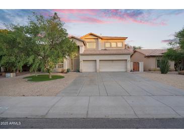Spacious two-story home with a three-car garage and a well-manicured front yard at 249 E Palomino Ct, Gilbert, AZ 85296