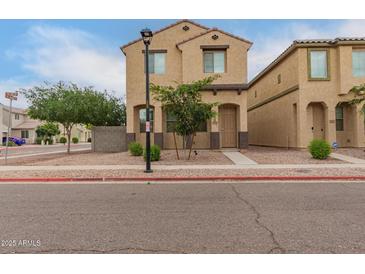 Two-story home with brown stucco, a tile roof, desert landscaping and simple architectural details at 3713 S 54Th Ln, Phoenix, AZ 85043