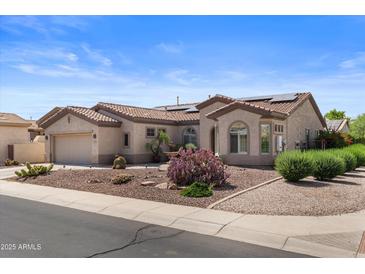 Inviting single-story home showcasing desert landscaping, solar panels and a neutral-toned exterior at 4234 E Narrowleaf Dr, Gilbert, AZ 85298