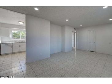 Bright living room features tile flooring, neutral paint, and recessed lighting at 5609 W Encanto Blvd, Phoenix, AZ 85035