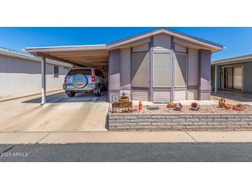 Charming single-story home featuring a covered carport and beautifully landscaped front yard at 5735 E Mcdowell Rd # 464, Mesa, AZ 85215