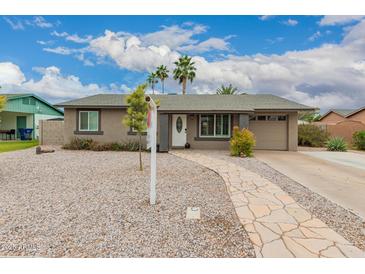Charming single-story home featuring a stone walkway and desert landscaping at 711 W El Alba Way, Chandler, AZ 85225