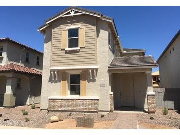 Charming two-story home featuring a neutral color scheme, decorative shutters, and a well-maintained front yard at 13473 N 158Th Ave, Surprise, AZ 85379