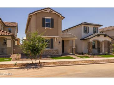 Charming two-story home with neutral stucco, landscaped front yard and covered entrance at 13473 N 158Th Ave, Surprise, AZ 85379