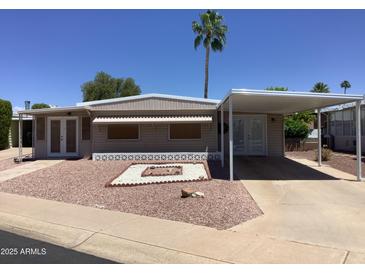 Charming single-story home with desert landscaping, awning-covered parking, and comfortable curb appeal at 2405 N Eastwood Way, Mesa, AZ 85215