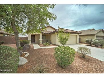 Charming single-story home featuring a two car garage and low maintenance desert landscaping at 25729 W St Charles Ct, Buckeye, AZ 85326