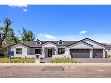 Charming updated one-story home featuring a modern design, professional landscaping, and a three-car garage at 4456 E Earll Dr, Phoenix, AZ 85018