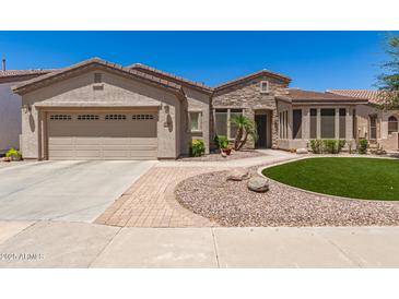 Charming single-story home featuring a two-car garage, desert landscaping, and a stone facade at 4626 E Blue Spruce Ln, Gilbert, AZ 85298