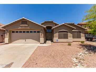 Charming single-story home with a two-car garage, well-kept landscape, and neutral colored stucco at 4826 W Ardmore Rd, Laveen, AZ 85339