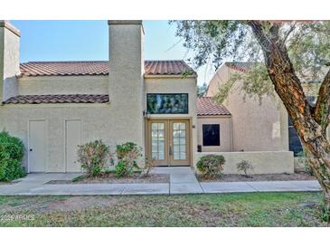 Charming home featuring a private entrance, warm stucco facade, and well-maintained landscaping at 602 N May -- # 17, Mesa, AZ 85201