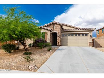 Charming home featuring stone accents, a well-maintained yard, and a two-car garage at 10849 S 175Th Dr, Goodyear, AZ 85338