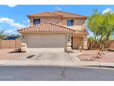 Charming two-story home featuring a tiled roof, a two-car garage, and low-maintenance desert landscaping at 12709 N El Frio St, El Mirage, AZ 85335