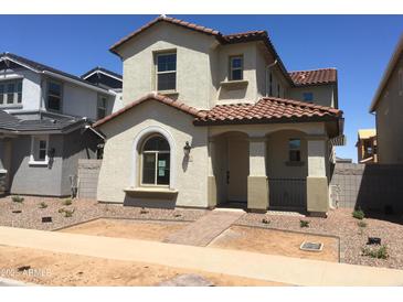 Charming two-story home featuring a red tile roof, stucco siding, and a welcoming front porch at 13481 N 158Th Ave, Surprise, AZ 85379