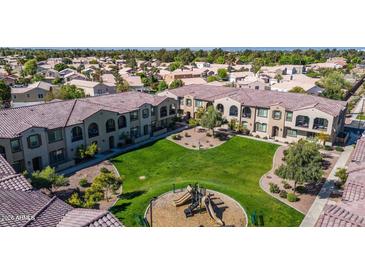 Attractive condo community boasts lush green space and a playground for outdoor enjoyment at 155 N Lakeview Blvd # 268, Chandler, AZ 85225