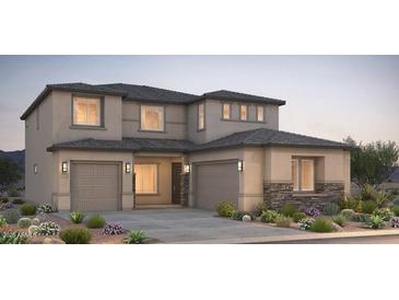 Beautiful two-story home with three-car garage and stone accents at 16711 W Questa Dr, Surprise, AZ 85387