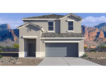Two story home with neutral paint, gray trim, gray roof, and mountains in the background at 1785 W Solstice Ave, Apache Junction, AZ 85120