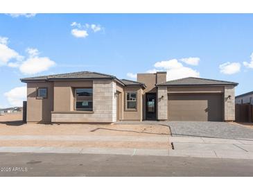 Charming single-story home with a neutral color palette, well-maintained landscaping, and a two-car garage at 24791 N 169Th Dr, Surprise, AZ 85387