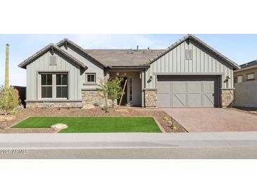 Charming single-Gathering home with stone accents, manicured front yard, and two-car garage at 32541 N 135Th Dr, Peoria, AZ 85383