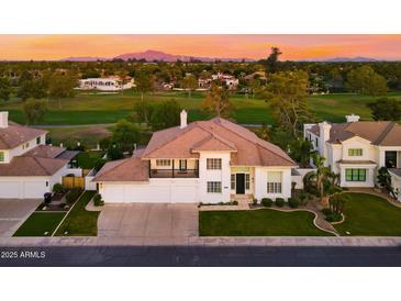Charming two-story home with a well-manicured lawn and professional landscaping with beautiful sunset scenery at 3665 S Jojoba Way, Chandler, AZ 85248
