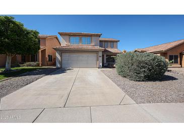 Charming two-story home with a well-maintained front yard and a spacious two-car garage at 4306 E Raven Rd, Phoenix, AZ 85044