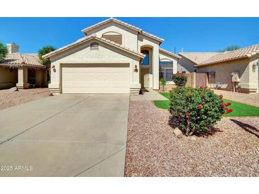 Charming single-Gathering home featuring stucco facade, attached two-car garage, and desert landscaping in front yard at 13620 N 82Nd Ln, Peoria, AZ 85381