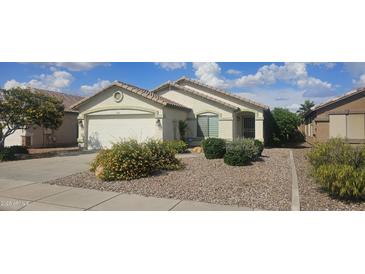 Charming single-story home with a well-manicured yard, desert landscaping, and a two-car garage at 14767 N 148Th Ave, Surprise, AZ 85379